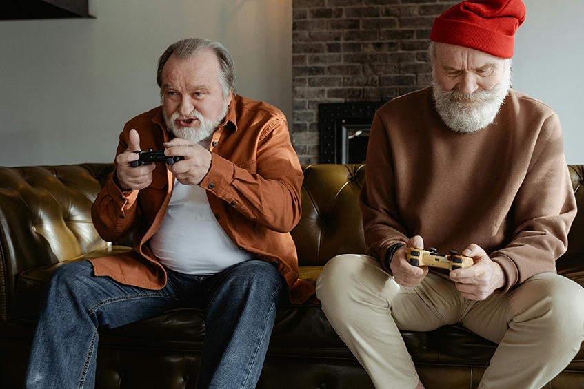 Two elderly men playing video games